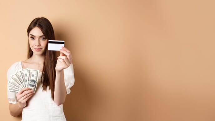 A young woman who prefers cashless payments than using dollar bills